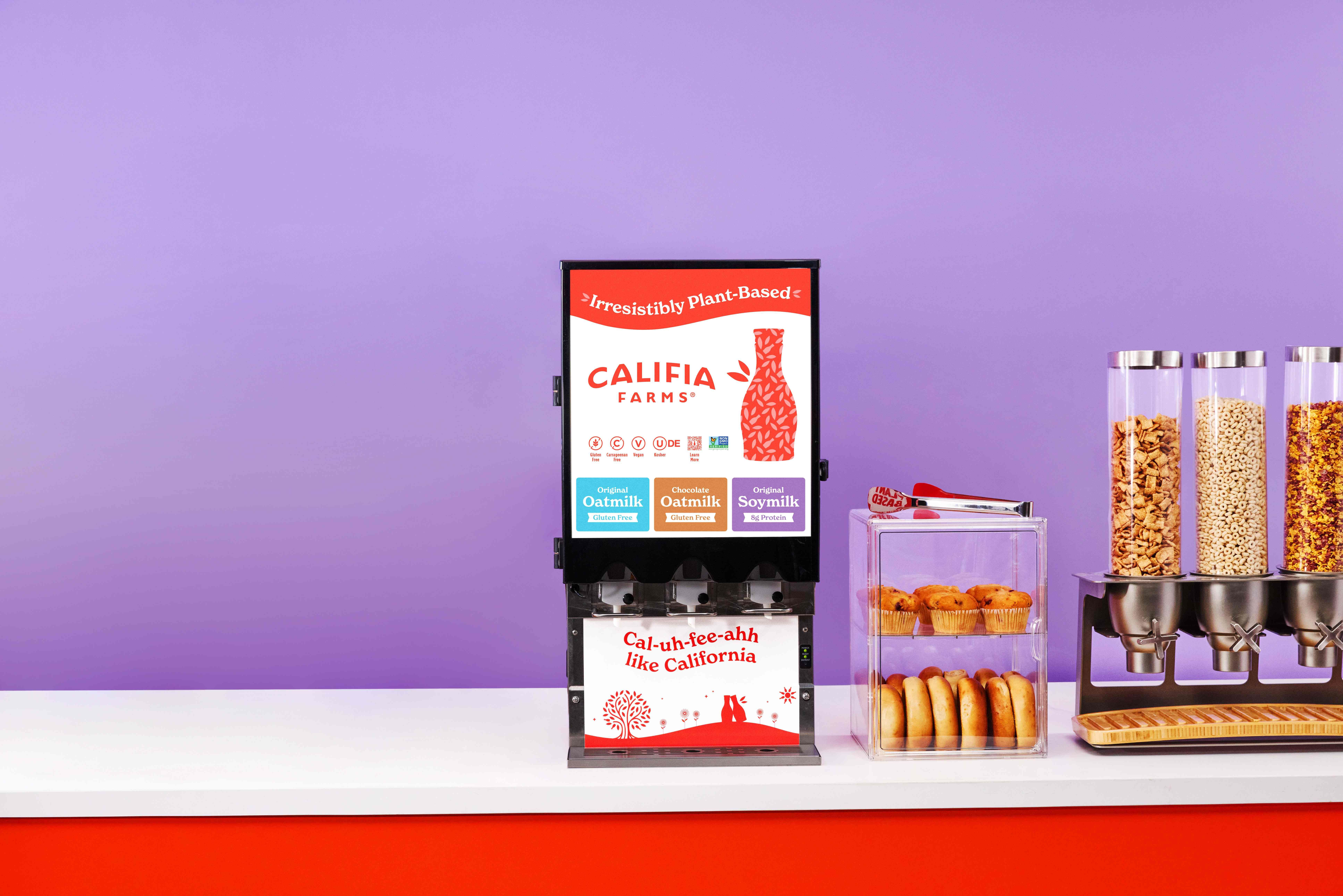 Picture of Califia Farms Dispensers in three flavors. Chocolate Oat Milk, Oat Milk, and Soy Milk with cereal and assorted pastries.
